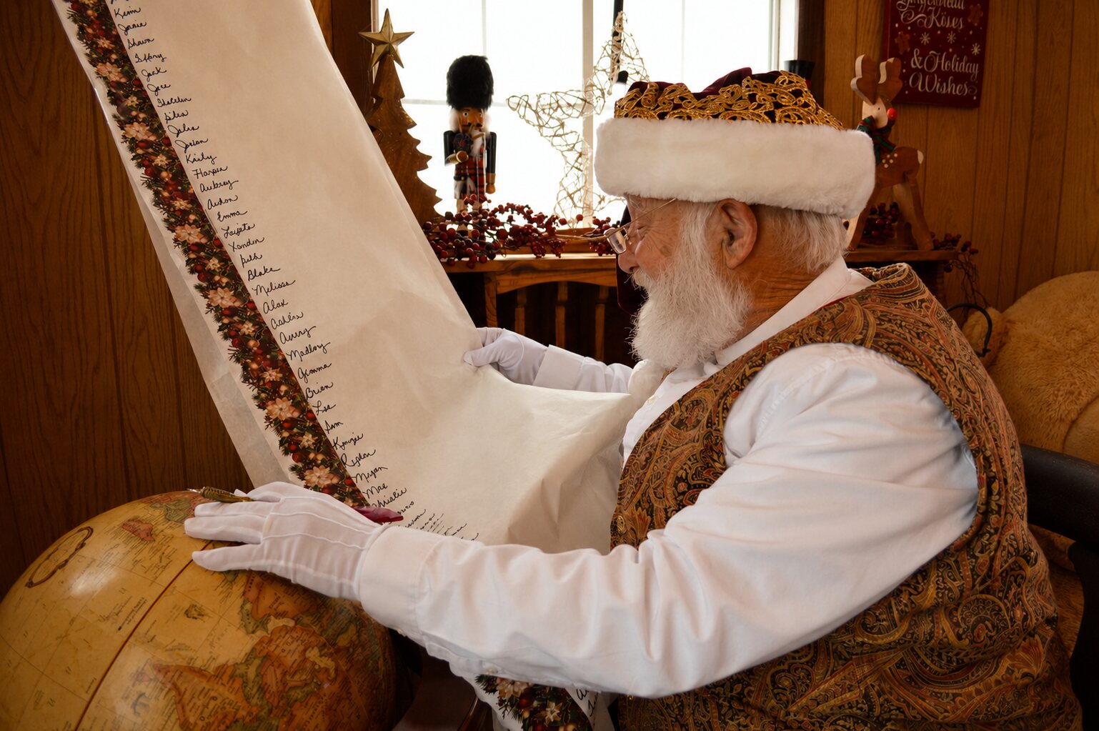 Santa checking a long handwritten list of children's names