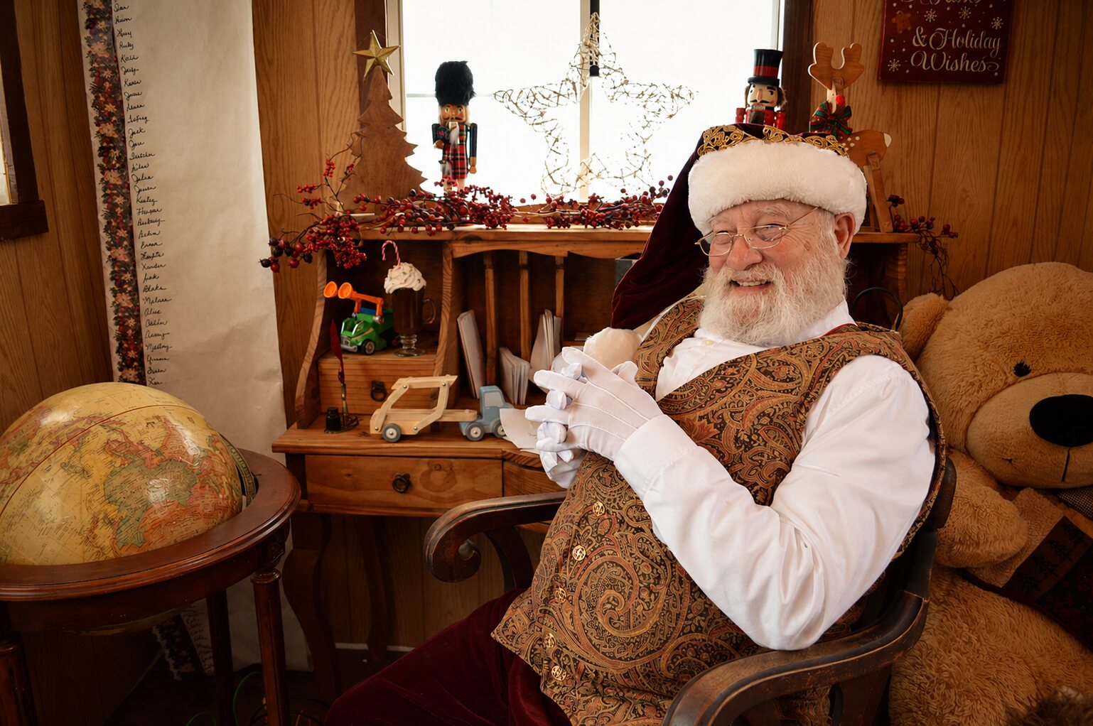 Santa seated and smiling in his festive workshop